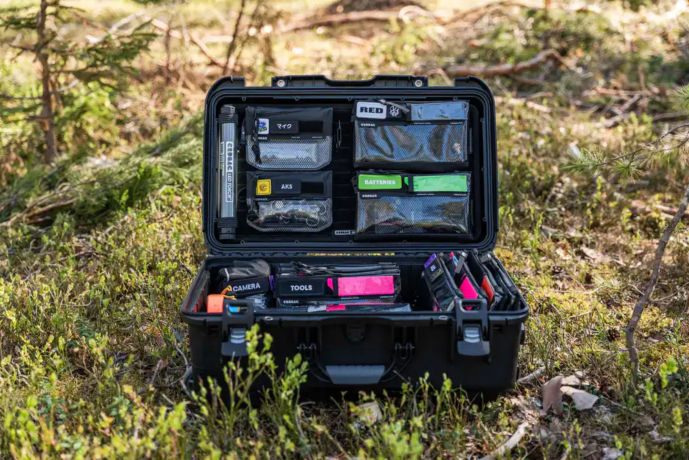 Carefully packing outdoor gear into a sturdy box